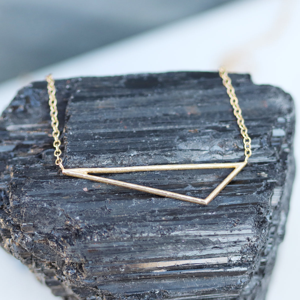Pendentif en forme de coin